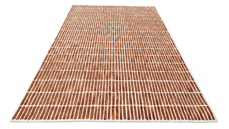 Rust and ivory striped wool area rug with textured tufted grid pattern and fringe edge.