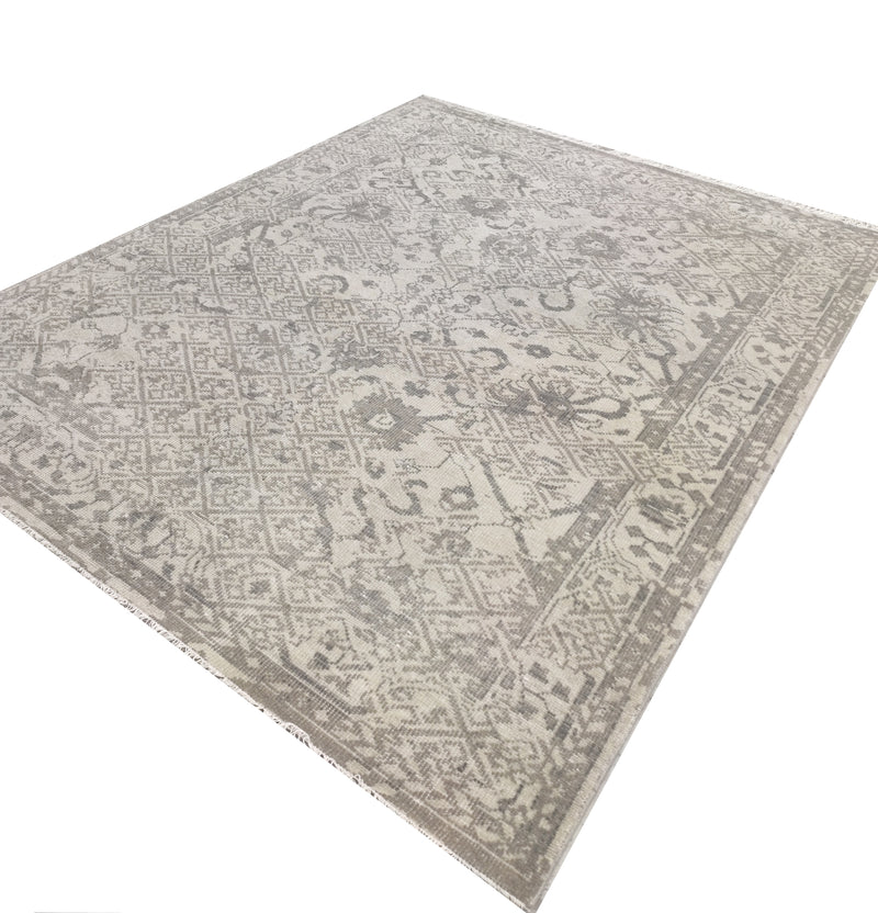 Hand-knotted vintage rug with all-over muted greige motif, angled view