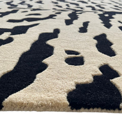 Aethel Abstract Tiger Stripe Hand Tufted Rug in Black & Sand