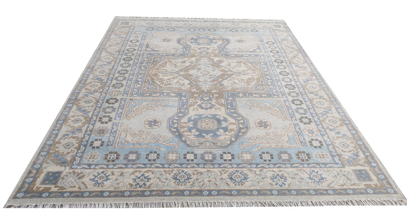 Sky blue and taupe Oushak-style rug with central medallion, ornate repeating corner motifs