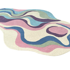Side angle view of Serpentine pastel hand-tufted wool rug with organic curved design