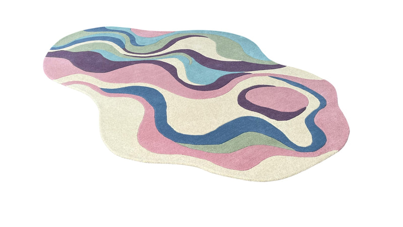 Side angle view of Serpentine pastel hand-tufted wool rug with organic curved design