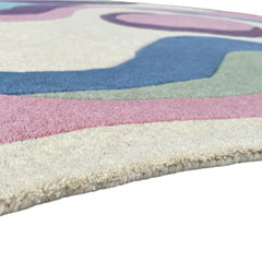 Close-up side view of Serpentine hand-tufted wool rug with soft pastel colors and textured pile