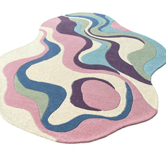 Serpentine pastel irregular wool area rug styled as a modern artistic statement piece