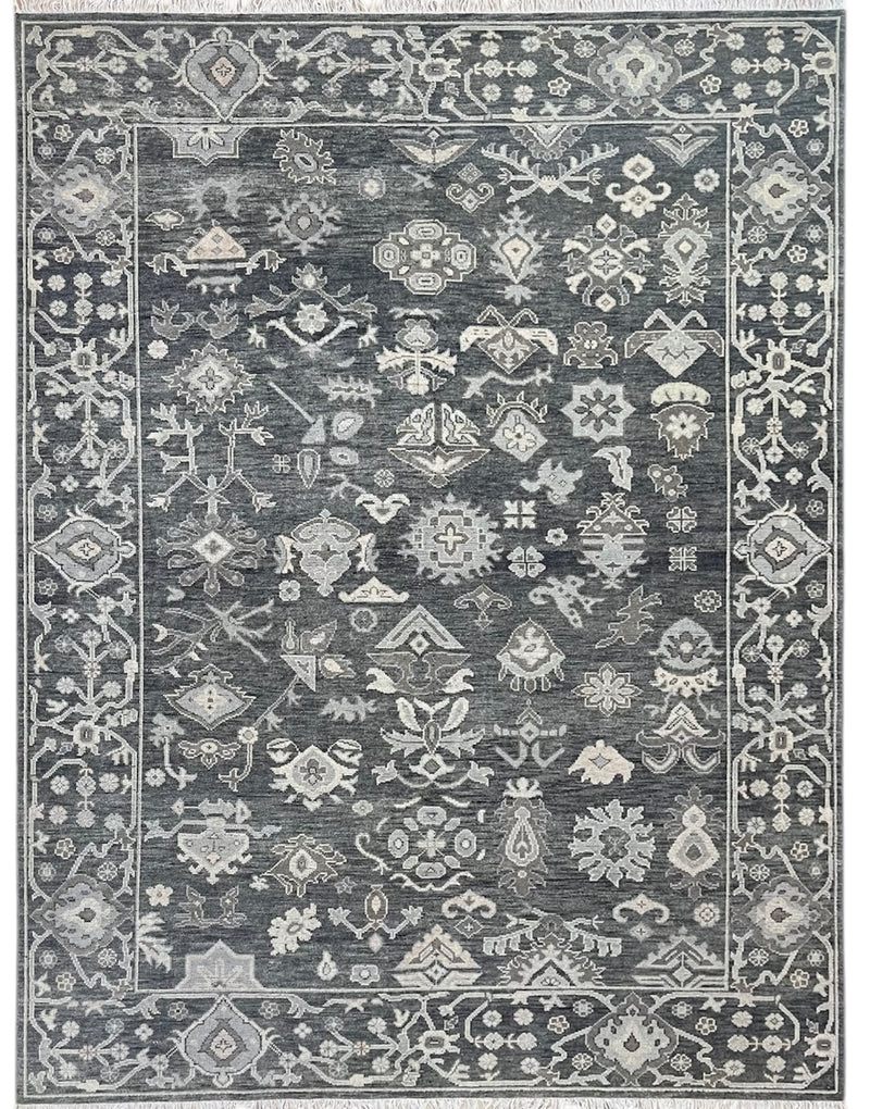 Charcoal hand-knotted wool rug with dense vintage floral pattern and ornamental border