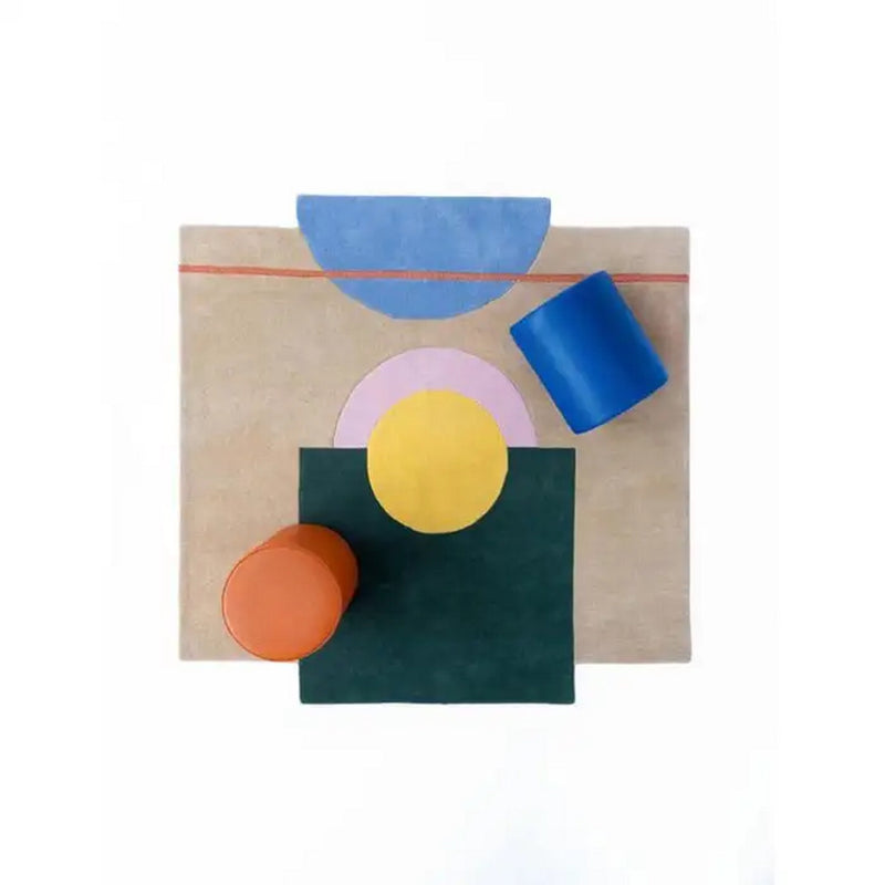 Beige abstract geometric wool rug with teal squares, yellow circle, orange and blue blocks.